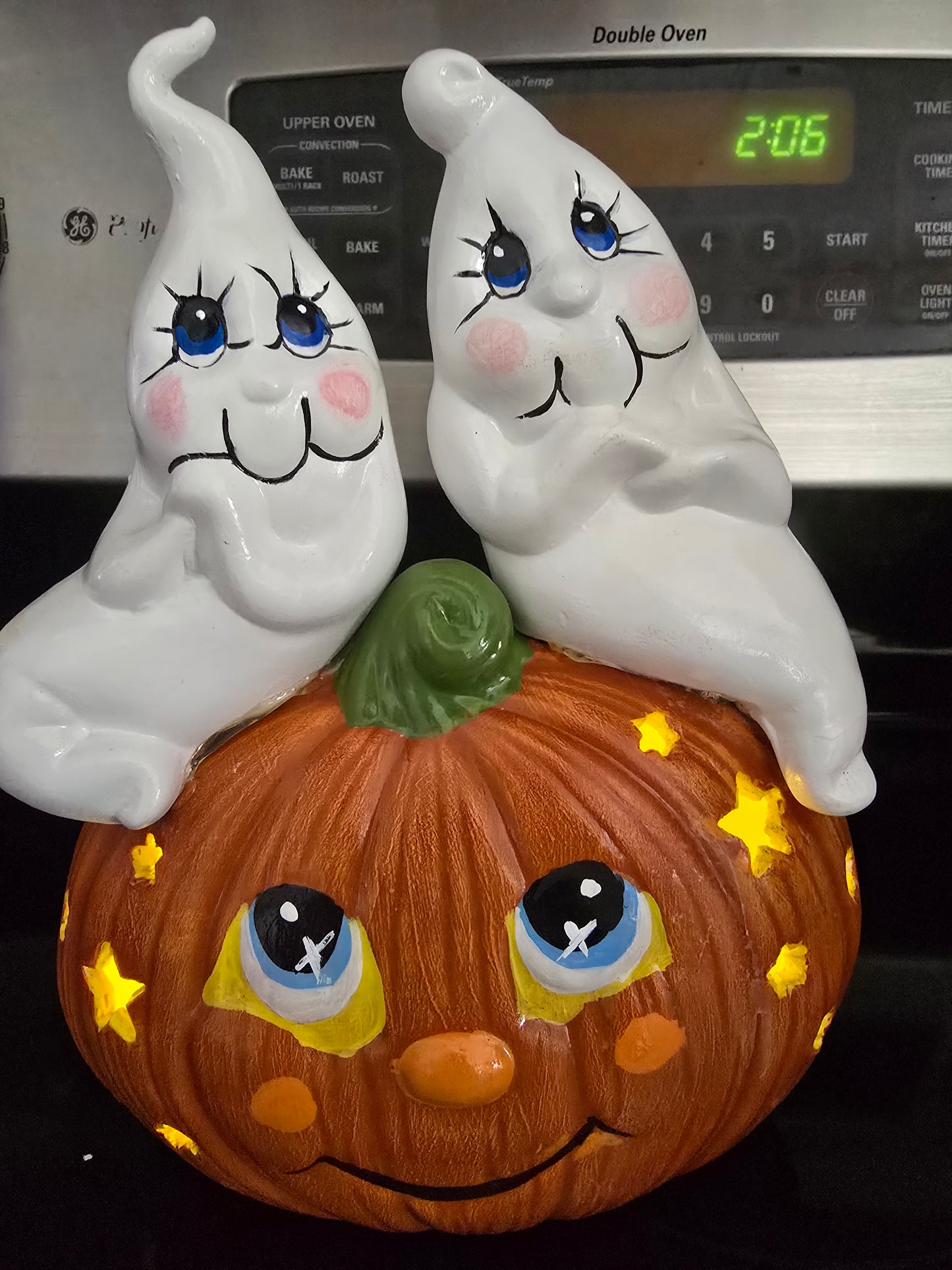 Ghosts Sitting on Pumpkin