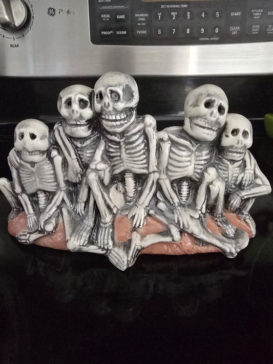 collection of Skeletons on a log