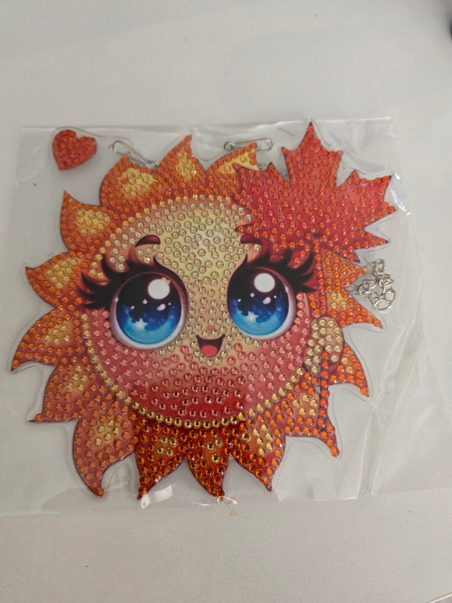 Sun wall hanging with face and leaves